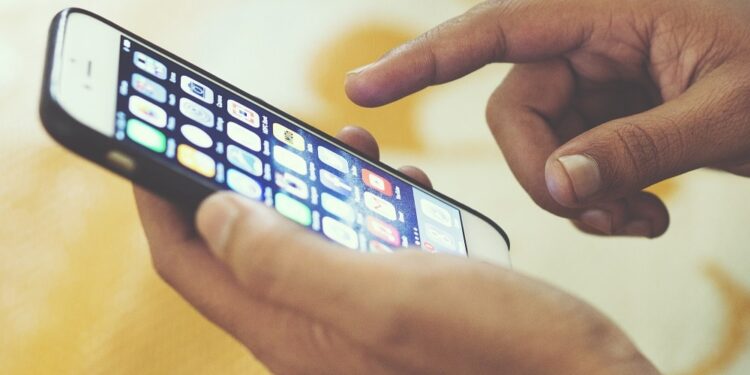 Hand swiping iPhone screen, location unknown, 25 February 2017. More: View public domain image source here