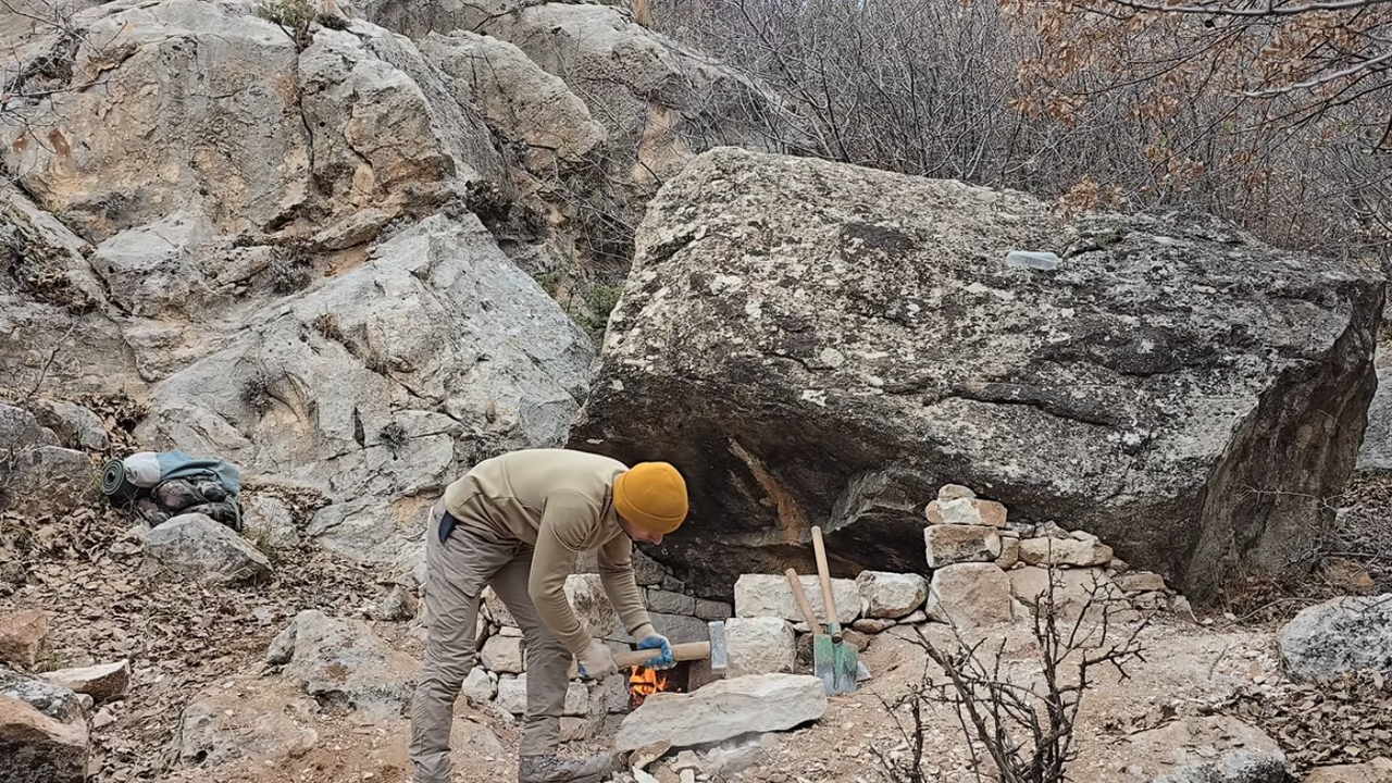 Cabana de pedra primitiva, robusta e confortável, com lareira